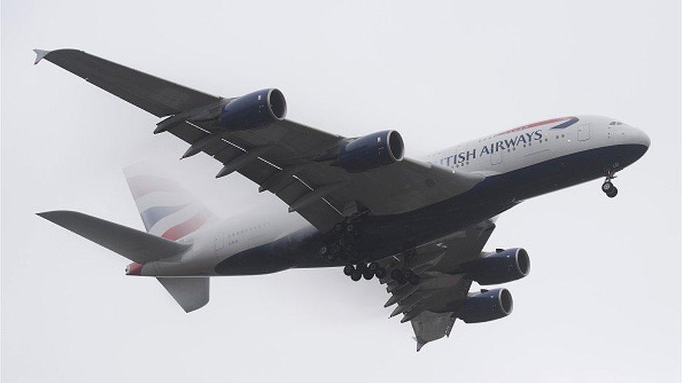 A British Airways Airbus A380 comes in through the fog to land at Heathrow Airport