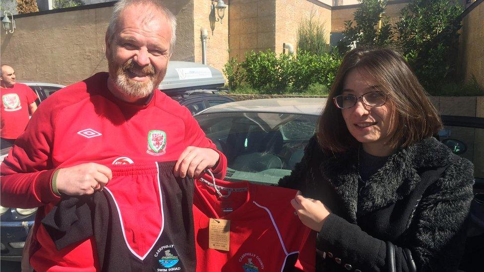 Kevin Davies handing over donations of shirts to a charity in Georgia on one of his many foreign trips supporting Wales