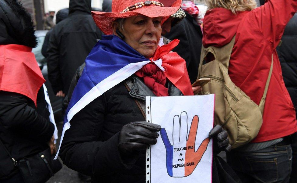 Red scarves - opponents of the yellow vests - take part in a rally in Paris, January 27, 2019