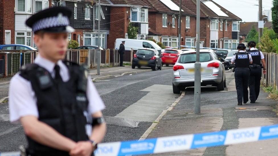 Police officers near to the scene on Kingsheath Avenue