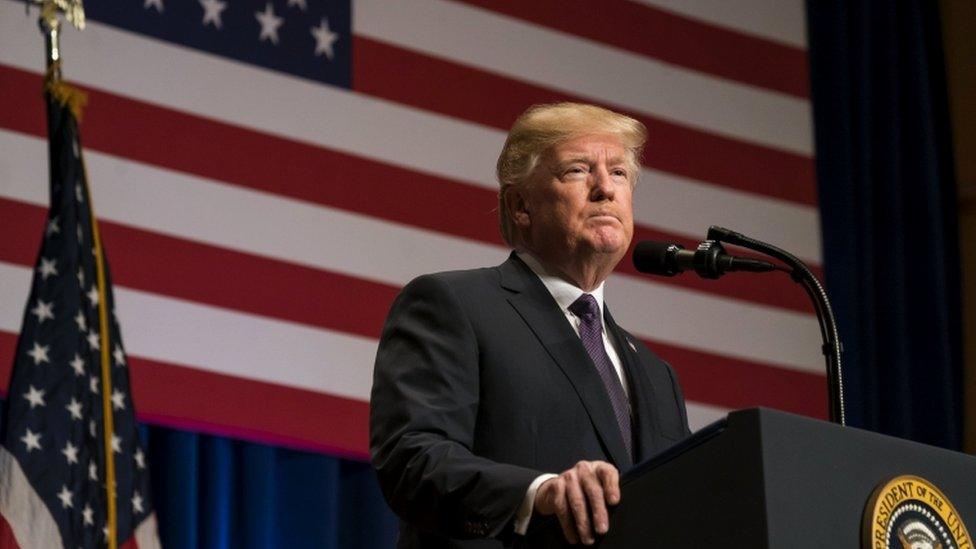 President Trump clutches the podium and addresses the audience during national security speech