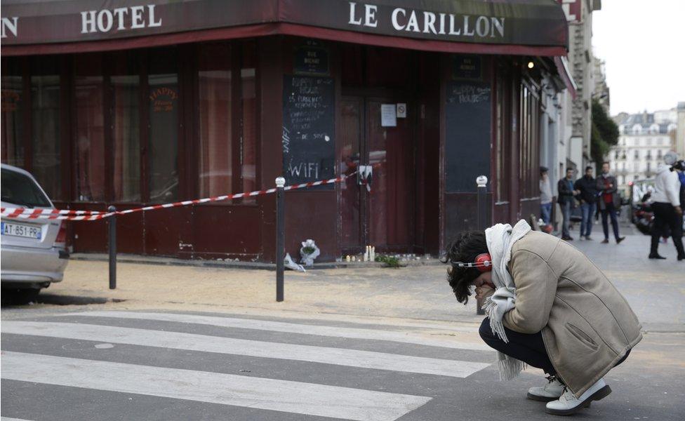 A woman mourns outside Carillon bar in Paris on 14 November, 2015