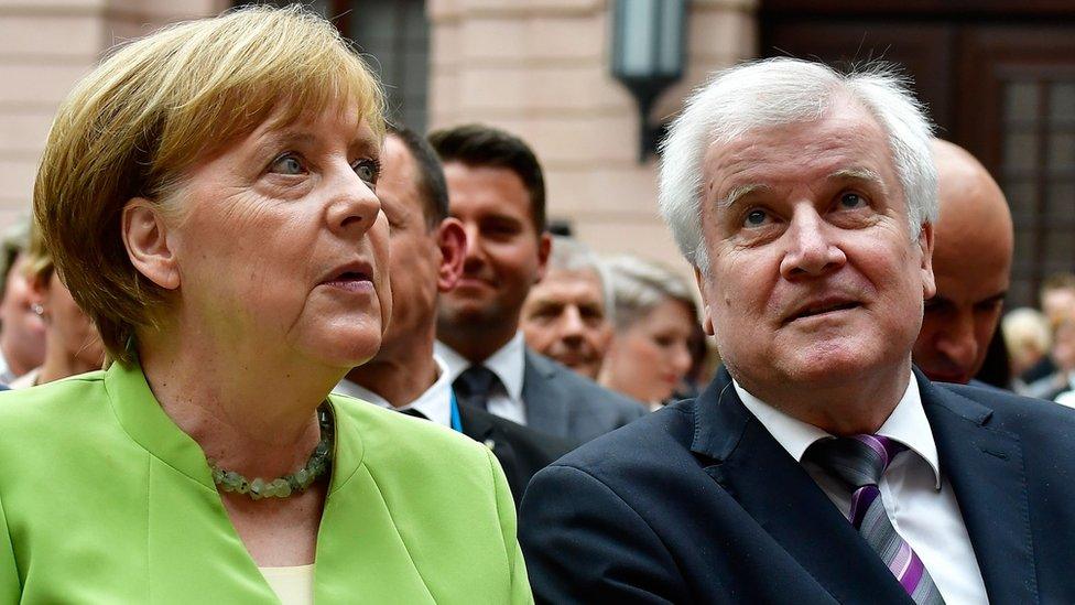 Angela Merkel and German Interior Minister Horst Seehofer attend a Berlin event on the occasion of the World Refugee Day on June 20, 2018