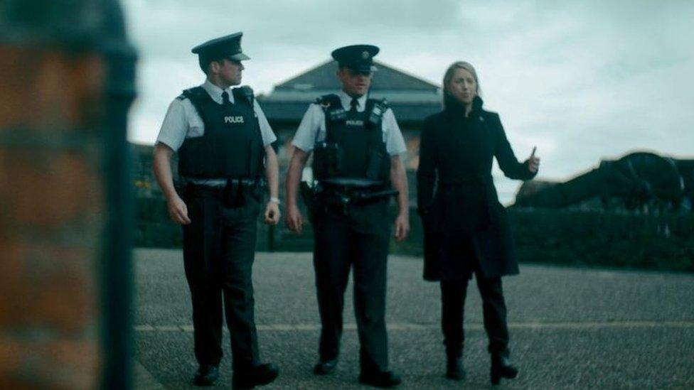 Emma Vardy talks to police officers in Derry