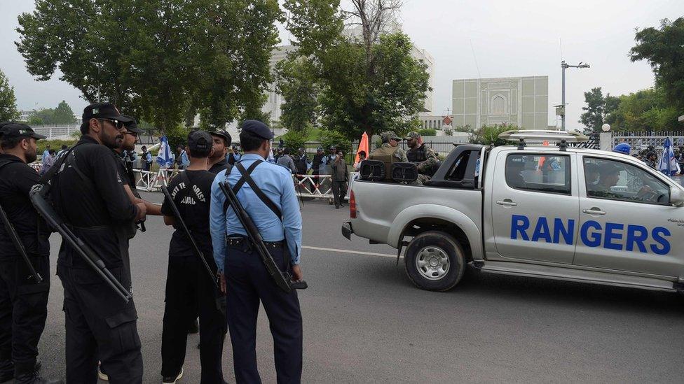 Pakistani paramilitary soldiers and policemen cordon off the main entrance of the Supreme Court building during a hearing on the Panama Papers case in Islamabad on July 28, 2017.