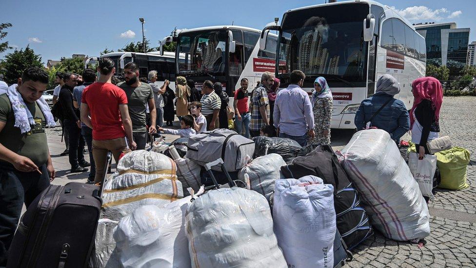 Syrian refugee families wait with other volunteers to board buses returning to neighbouring Syria in the Esenyurt district of Istanbul