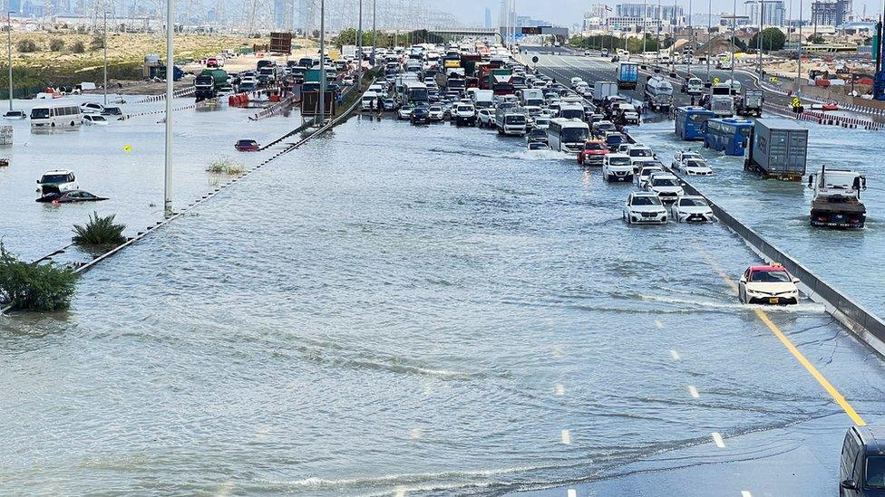 Cars are stuck on a flooded road after a rainstorm hit Dubai