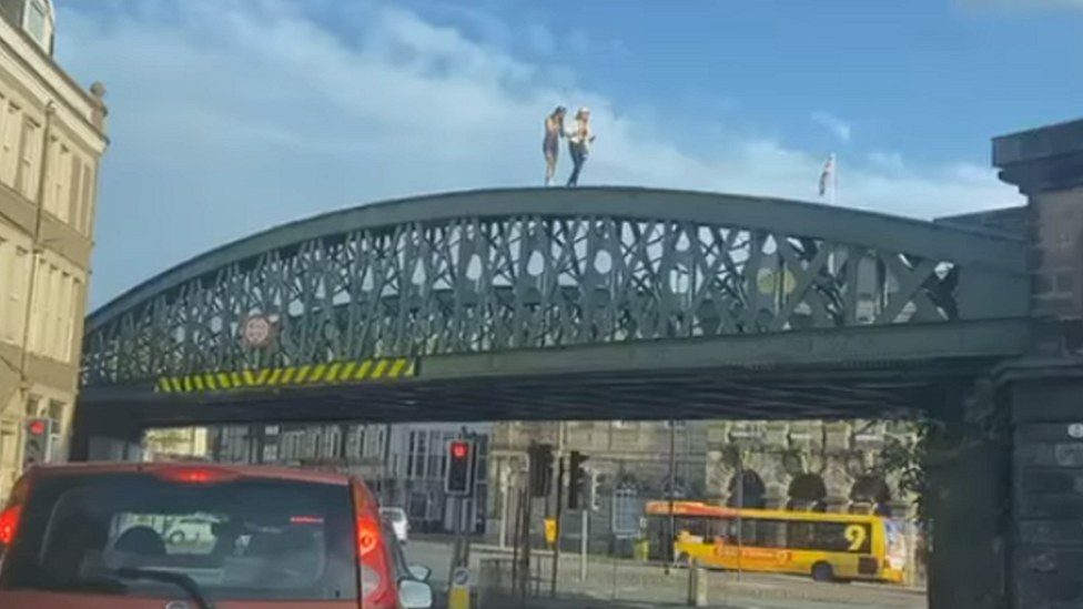 Image of 2 girls crossing a bridge