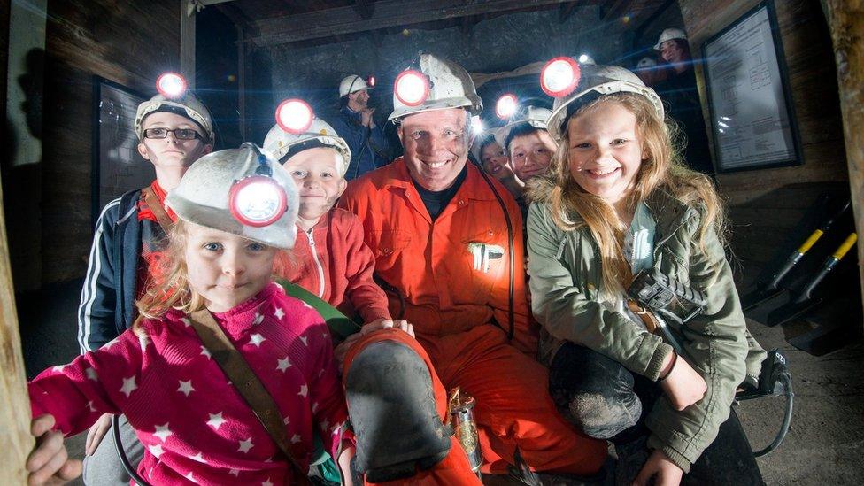 Former miner and visitors underground