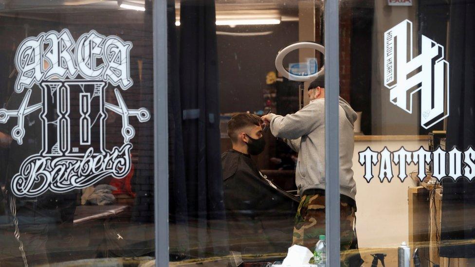 A man gets his hair cut in a Newcastle barber's shop