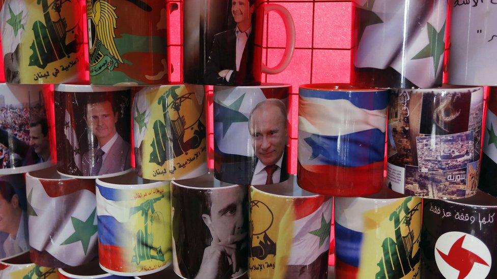 Mugs displaying portraits of Syrian President Bashar al-Assad and his Russian counterpart Vladimir Putin are seen in central Damascus on April 7, 2017