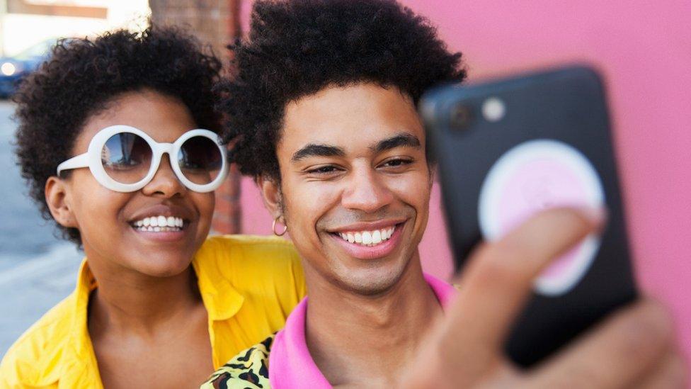 Couple smiling as they take a selfie