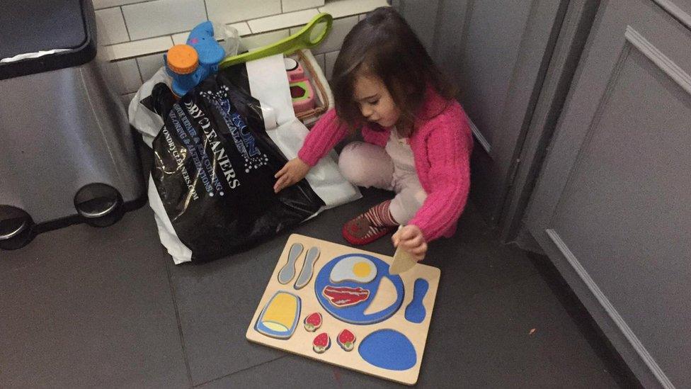 Mirella discovering a bag of toys as they are prepped for the BHF charity bins