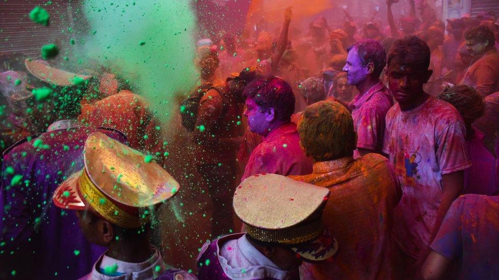 People daubed in colors celebrations for Holi in Kolkata, India on 05 March 2023.