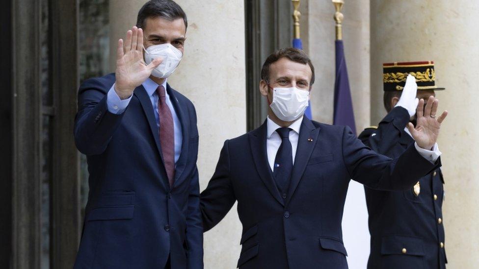 French President Emmanuel Macron (R) greets Spanish Prime Minister Pedro Sanchez (L)