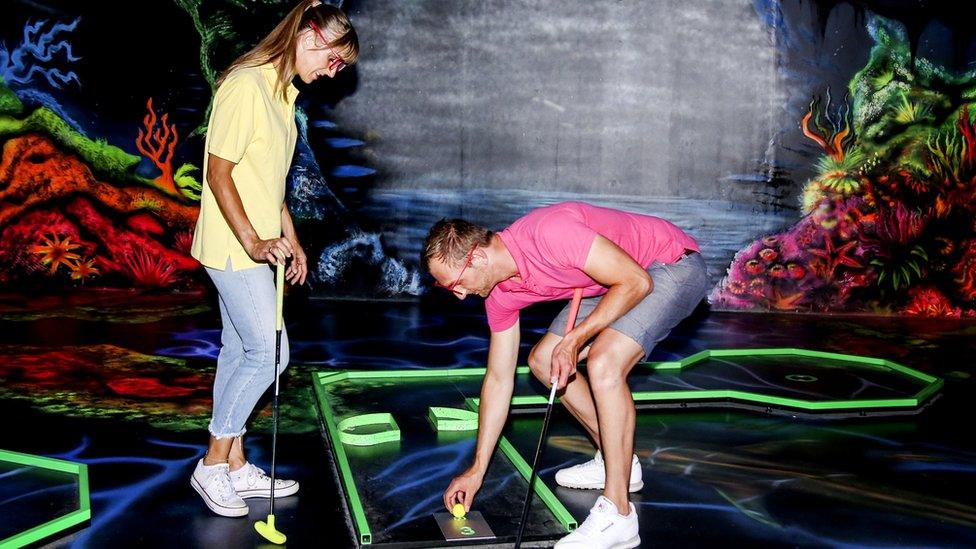 People playing crazy golf