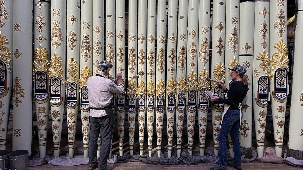 Artists restoring the pipes