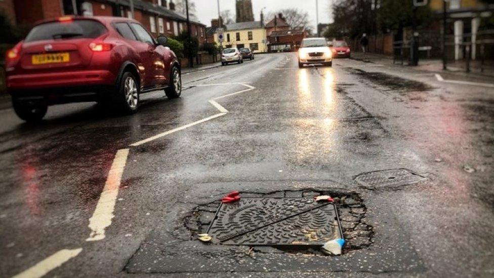 The manhole cover repaired with rubber gloves