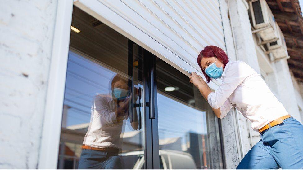 Young worker shutting up premises