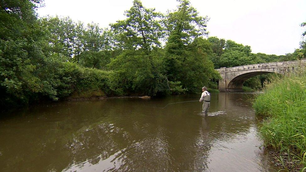 Fisherman in river