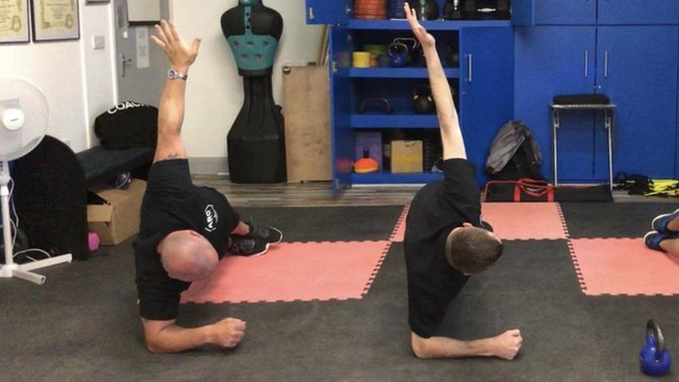 clients doing a side plank