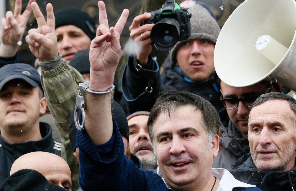 Georgian former President Mikheil Saakashvili flashes a victory sign after he was freed by his supporters in Kiev