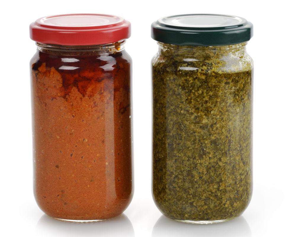 A jar of pesto on the right, with a jar of something else on the left