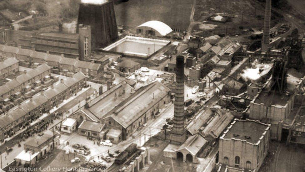 View of the pit and crowds in the street after the disaster