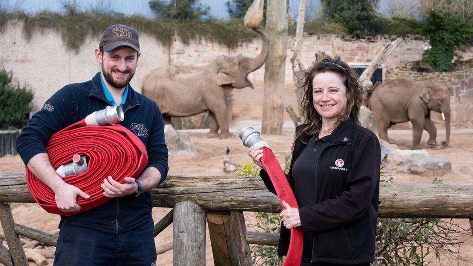 Diane Miller and Chester Zoo employee with fire hoses