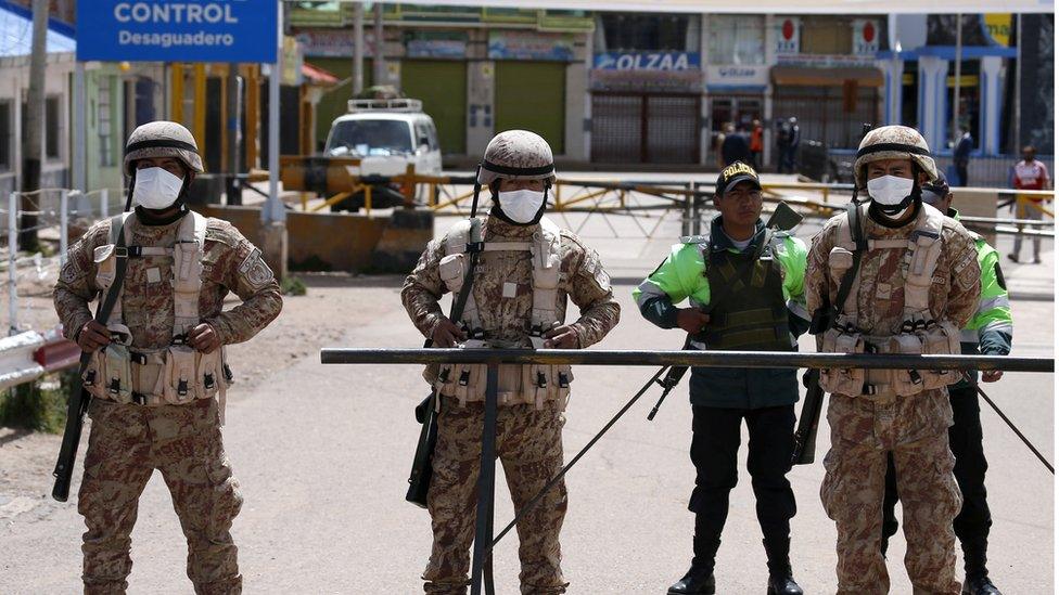 Peruvian soldiers stand at the border between Peru and Bolivia after Peru"s government"s announcement of the border closure in a bid to slow the spread of the new coronavirus (COVID-19), in Desaguadero