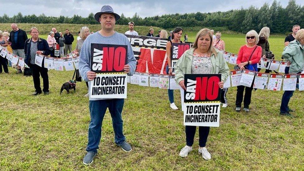 Campaigners holding banners at a previous protest