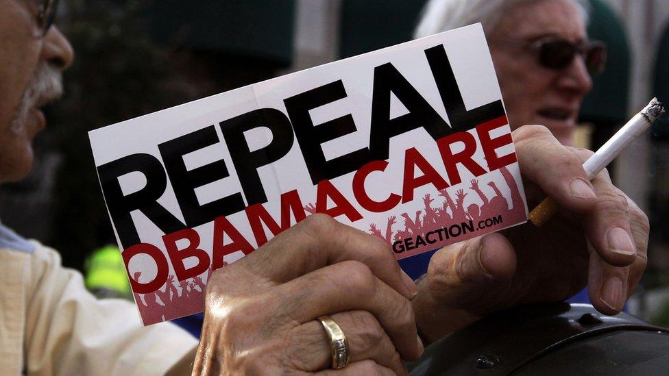 A protester holds a "repeal Obamacare" sign