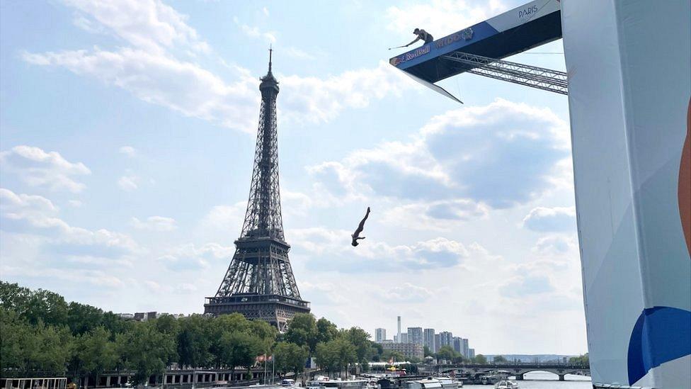 A diver jumps from a platform at the River Seine in Paris, France