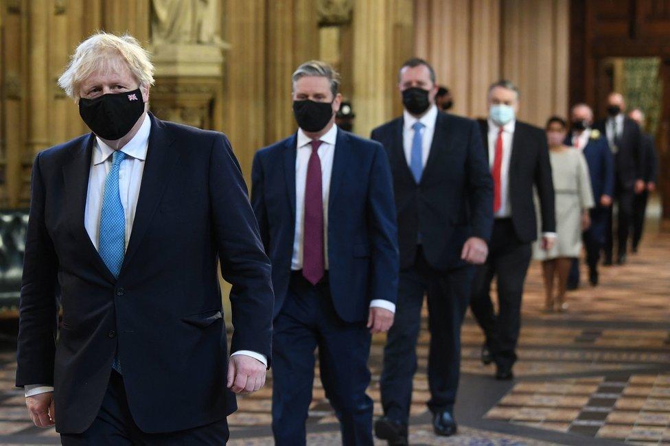 Prime Minister Boris Johnson and Labour leader Sir Keir Starmer walk through the Central Lobby on the way to the House of Lords to listen to the Queen's Speech