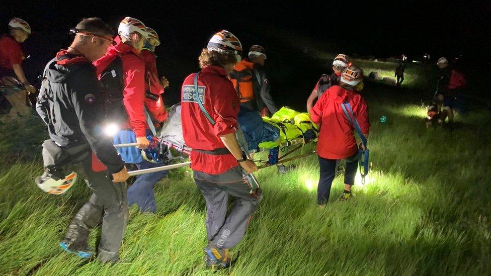 Members of Keswick Mountain Rescue Team rescuing an injured man