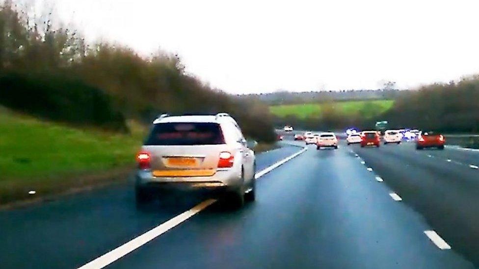 Car undertaking police vehicle on M40