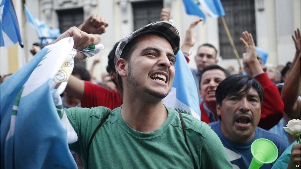 Demonstrators react as they hear the news that Congress has voted to withdraw President Otto Perez Molina's immunity from prosecution on 1 September, 2015.