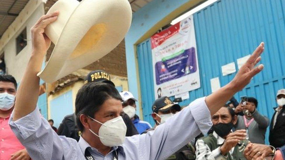 Peruvian presidential candidate Pedro Castillo (C) from the Peru Libre party arrives to vote in the town of Tacobamba, Cajamarca department, Peru, 11 April 2021