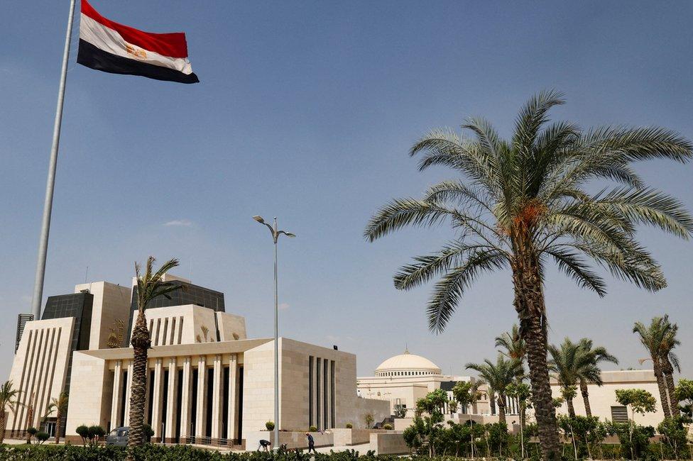 Egyptian workers are seen in front of the new headquarters of Egypt's parliament in the New Administrative Capital (NAC), east of Cairo, Egypt (21 June 2023)