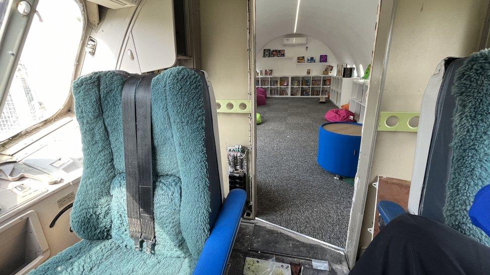 The cockpit of the plane looking into the library