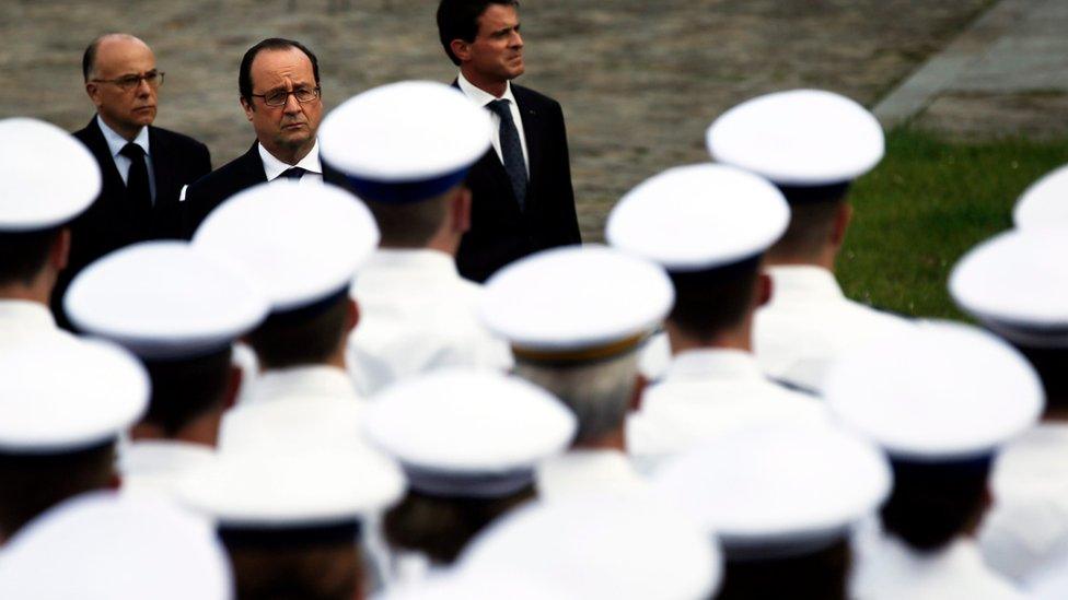 French President Francois Hollande (C), French Interior Minister Bernard Cazeneuve (L) and French Prime Minister Manuel Valls (R) attend a national ceremony in homage for the two victims of the 13 June Magnanville police stabbing attack, at the Yvelines Prefecture in Versailles, France, 17 June 2016.