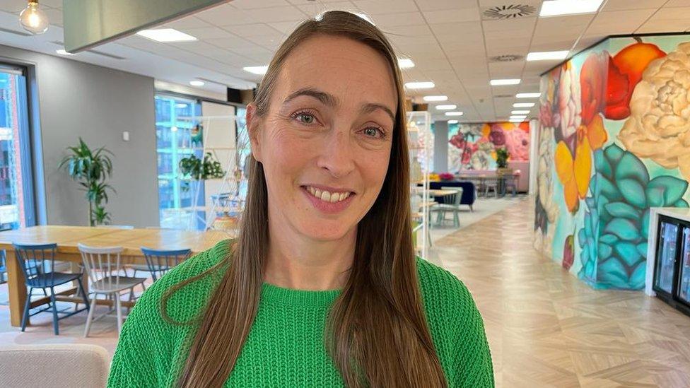 Sarah Rodgers from Forrest Brown wearing a green jumper and smiling at the camera