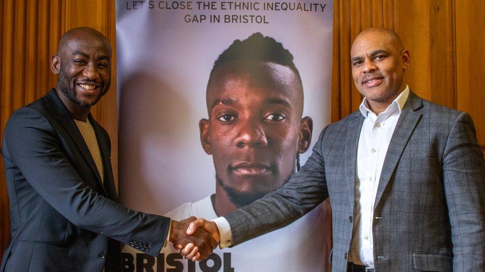 Poku Osei shaking hands with mayor Marvin Rees