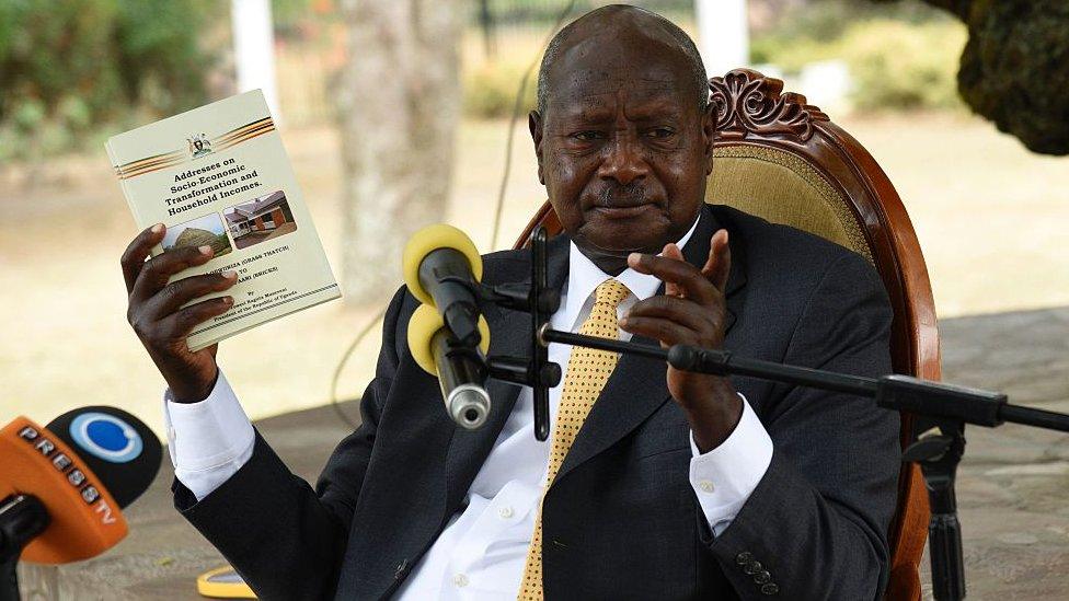 Newly re-elected president Yoweri Museveni, in power since three decades, gestures with booklets as he speaks during a press conference at his country house in Rwakitura, about 275 kilometres west of the capital Kampala on February 21, 2016.