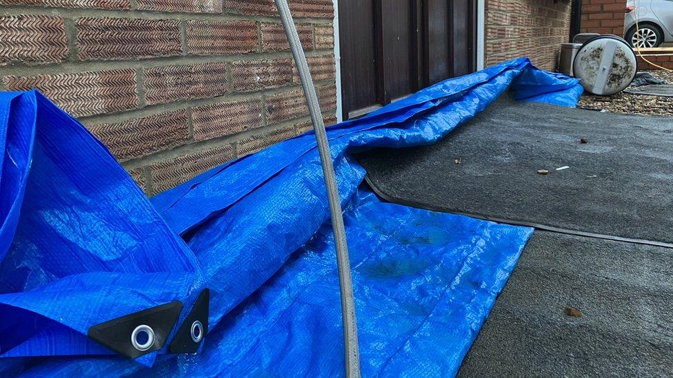 A makeshift barricade to stop water by Sheryl Carter's back door