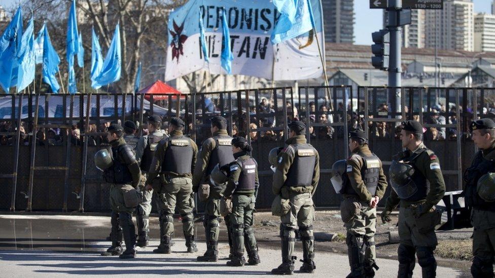 Riot police and Ms Fernandez supporters stand outside the court in Buenos Aires