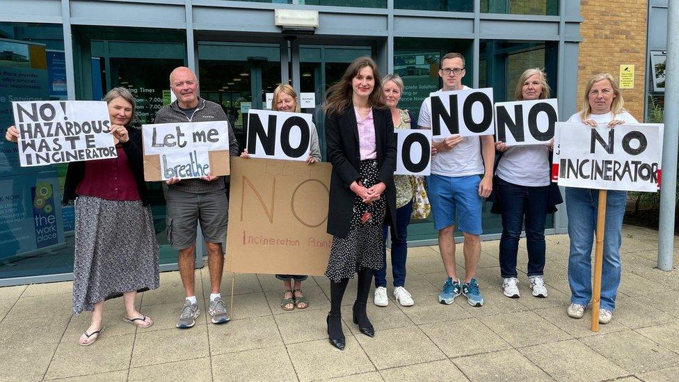 Residents hold placards saying no to the incinerator outside the planning inquiry