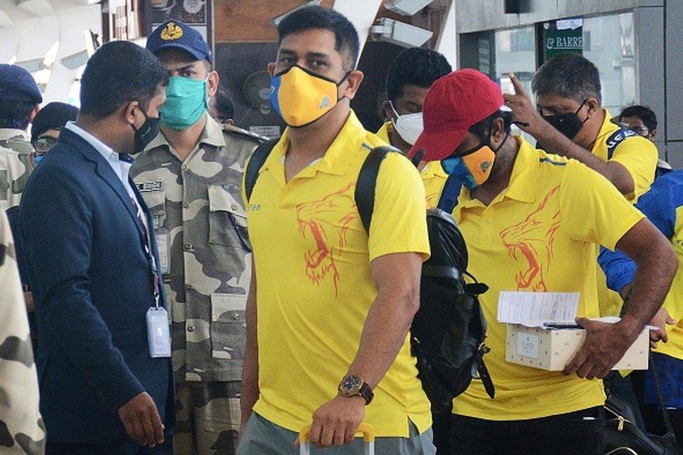 Chennai Super Kings captain Mahendra Singh Dhoni (C) arrives along with his teammates at the airport to take a flight to Dubai for the Indian Premier League (IPL) cricket tournament, in Chennai on August 21, 2020.