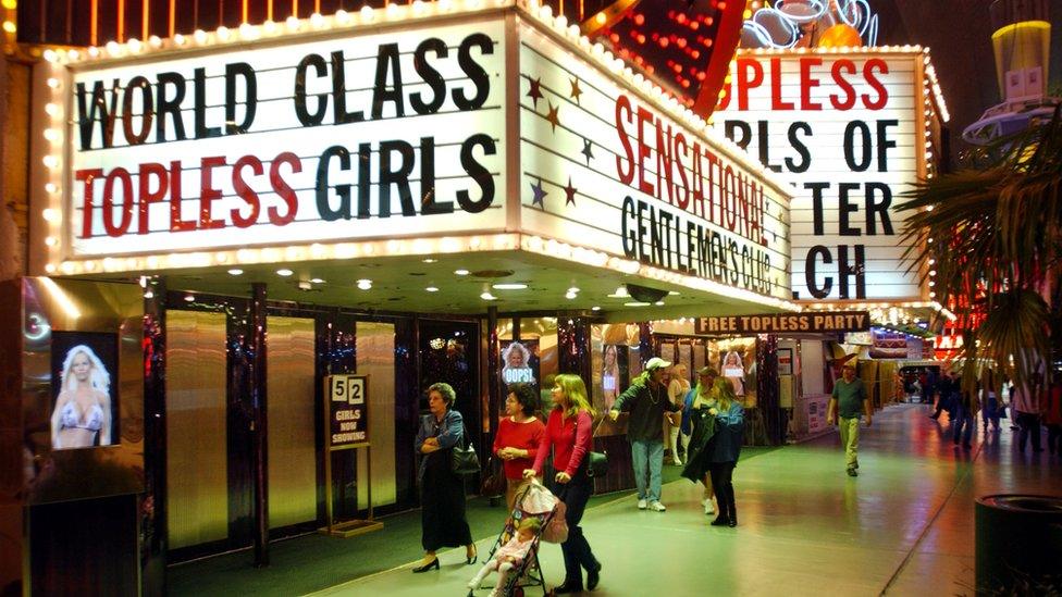 Image from 90s of a sign for 'World Class Topless Girls' in Las Vegas' Freemont Street