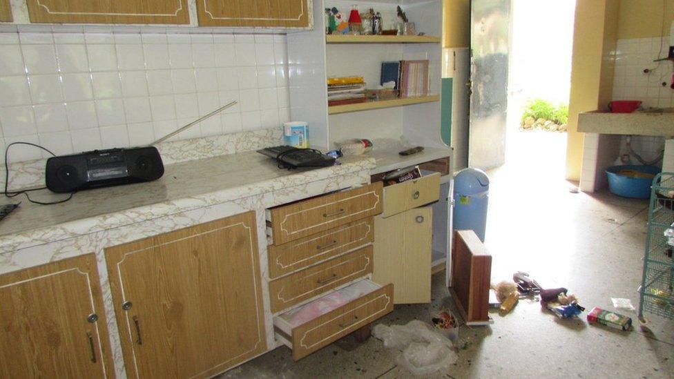 A photo shows drawers lying on a kitchen floor in the house where Christian Brothers live